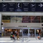 People push trollies, as they head to board a plane at Beirut International airport